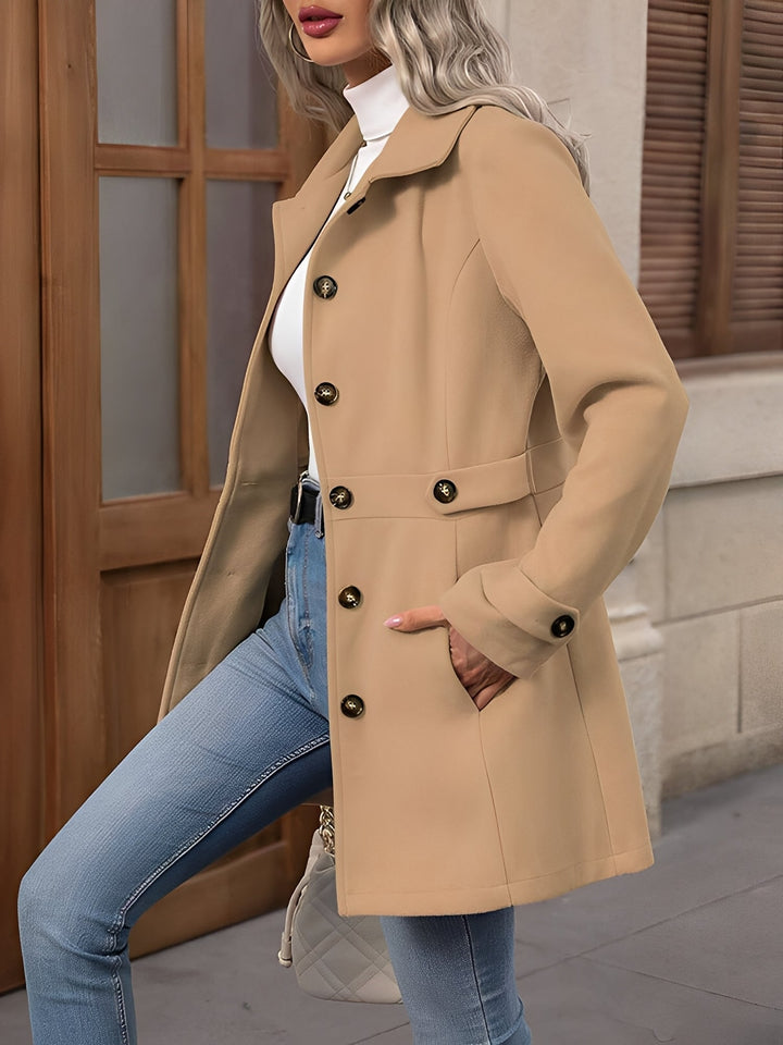 Stylish women's double-breasted trench coat with waist belt, sophisticated outerwear.