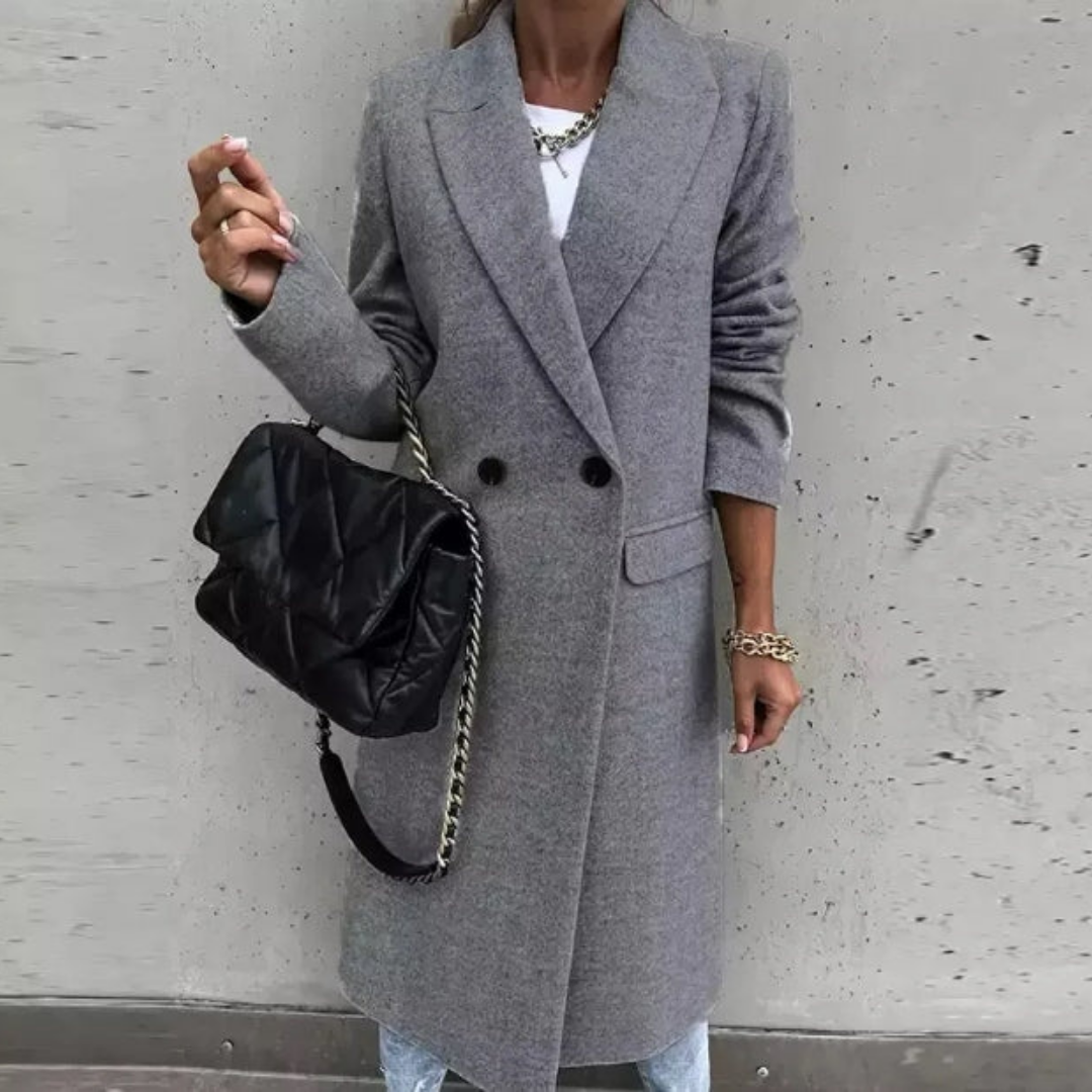 Close-up of lapel collar and double-breasted buttons on a stylish women's long formal trench coat outerwear.