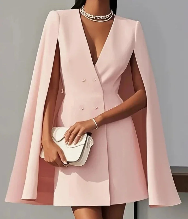 Sophisticated women's party mini dress, double-breasted with flowing cape sleeves. Modern chic fashion.
