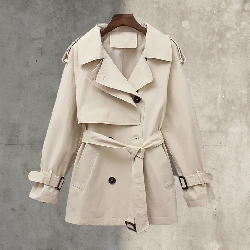 Classic ladies long trench coat, double-breasted with a stylish belt. Essential elegant outerwear for women.