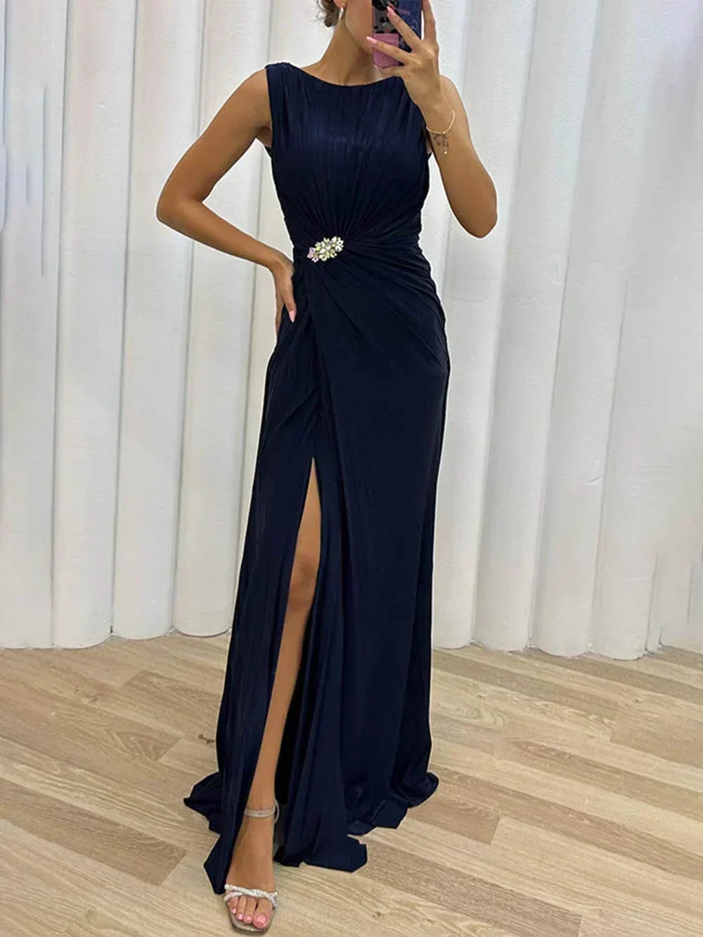 Sleeveless women's draped maxi wedding guest dress with elegant flowing fabric for special occasions.
