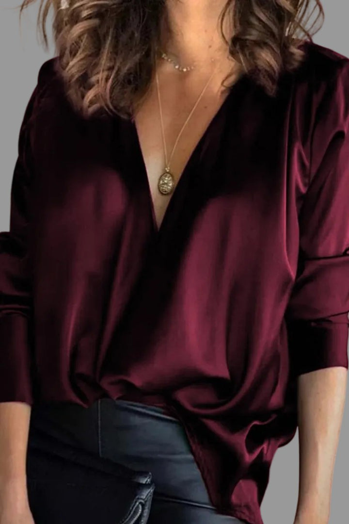 Stylish green draped V-neck blouse for women. Elegant relaxed fit, ideal for evening wear or formal events.