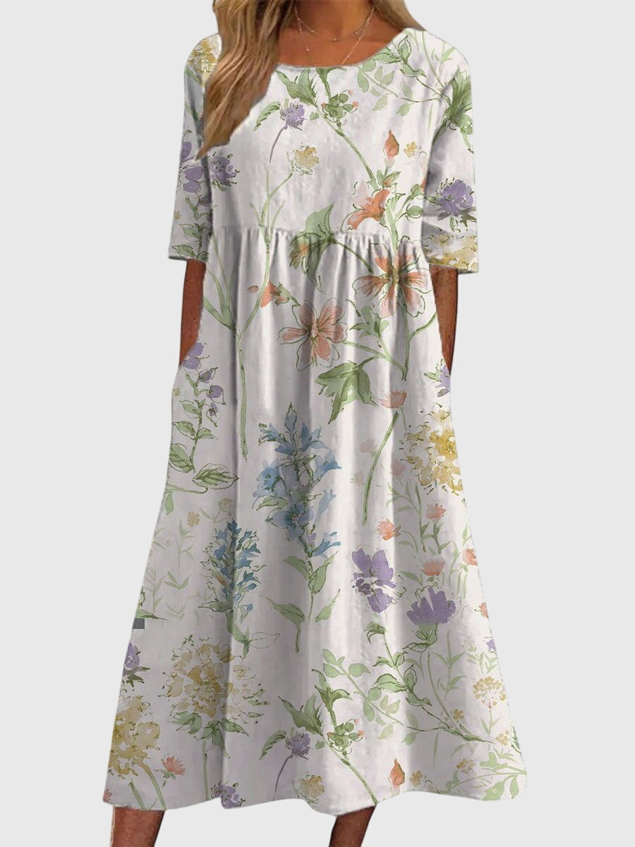 Flattering women's embroidered flowy midi dress in soft blue, offering an elegant, relaxed silhouette.