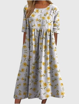 Beautiful women's embroidered flowy midi dress in sunny yellow, featuring relaxed fit & versatile style.