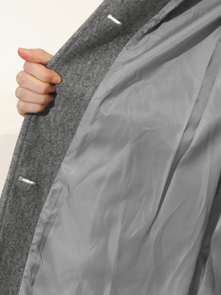 Fashionable women's fitted trench coat with classic button closure, an elegant workwear staple.