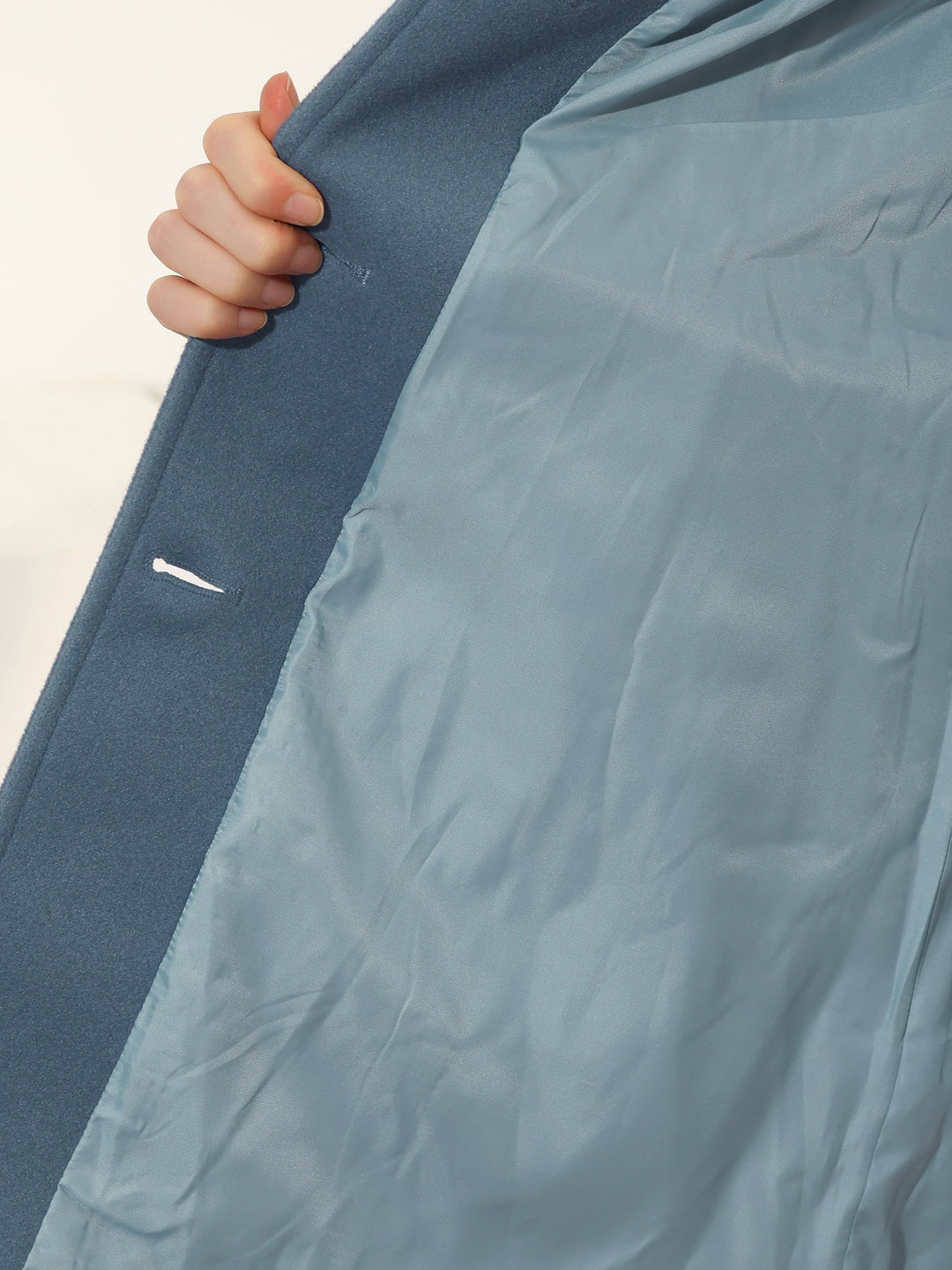 Classic women's fitted trench coat, elegant button-front outerwear for timeless workwear fashion.