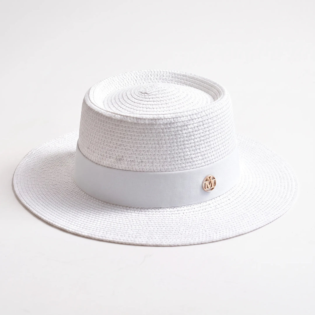 Chic women's wide brim sun hat with a flat top, ideal for stylish beach outfits and summer travel.