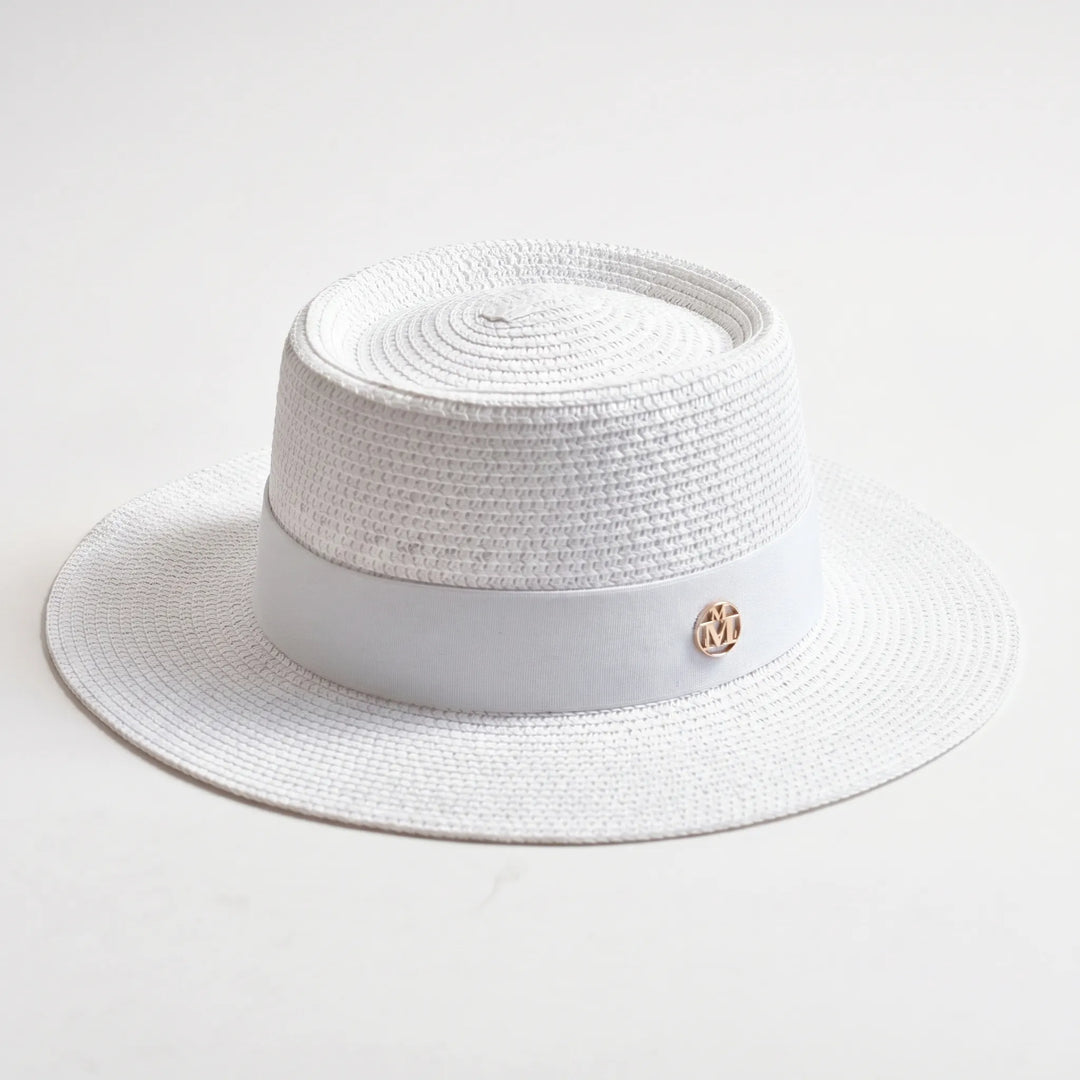 Women's flat top sun hat with a wide brim, a trendy summer accessory for beach days and travel.