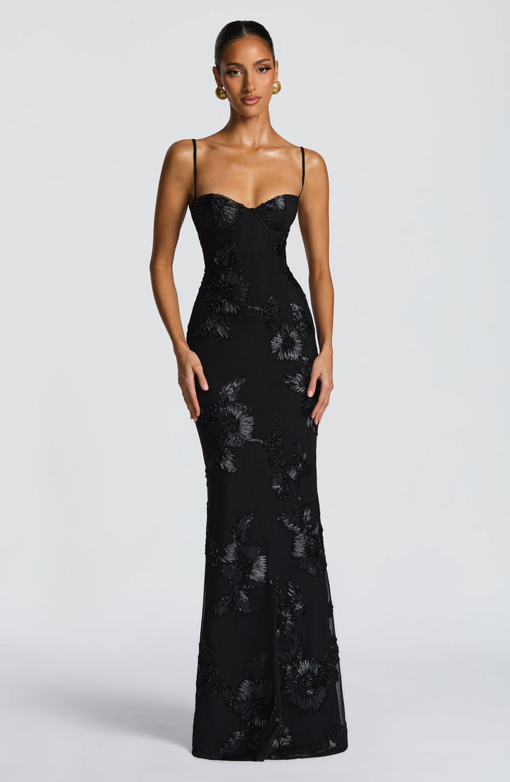 Beautiful women's mermaid evening dress, featuring intricate floral embellishments for a black tie event.