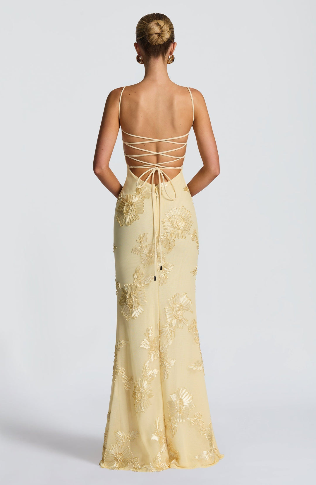 Women's elegant spaghetti strap maxi dress, designed with beautiful floral details for formal wear.