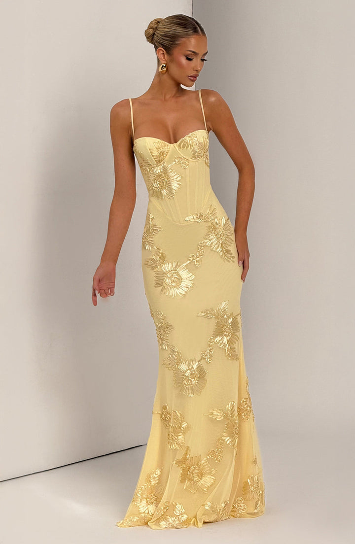 Full-length formal mermaid prom dress for women, adorned with delicate floral appliqués for an elegant look.