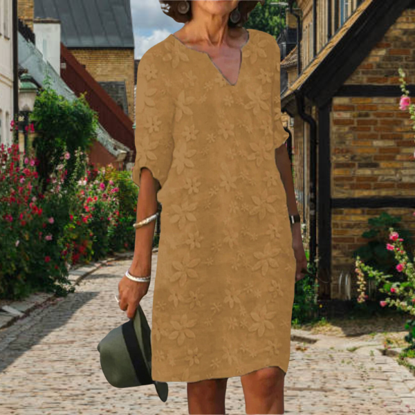 Women's midi dress featuring vibrant floral appliqué, 3/4 sleeves, and notch neck. A comfortable summer casual dress.