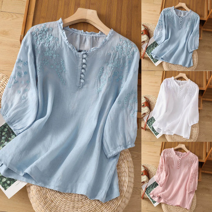Stylish floral button-front blouse for women. Embroidered top, perfect for warm weather fashion.