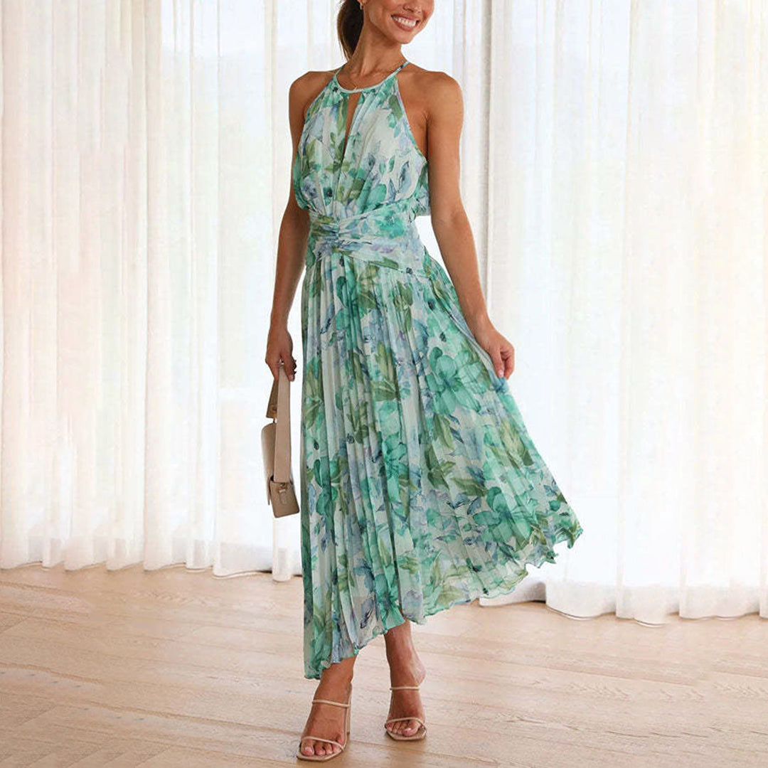 Elegant women's floral halter maxi dress, perfect for a wedding guest or summer garden party. Flowing pleated design.