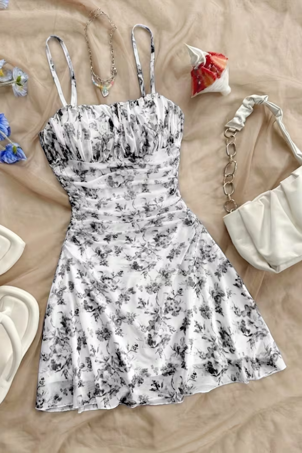 Stylish black floral mini dress for women, halter neck and flared hem, great for elegant summer events.