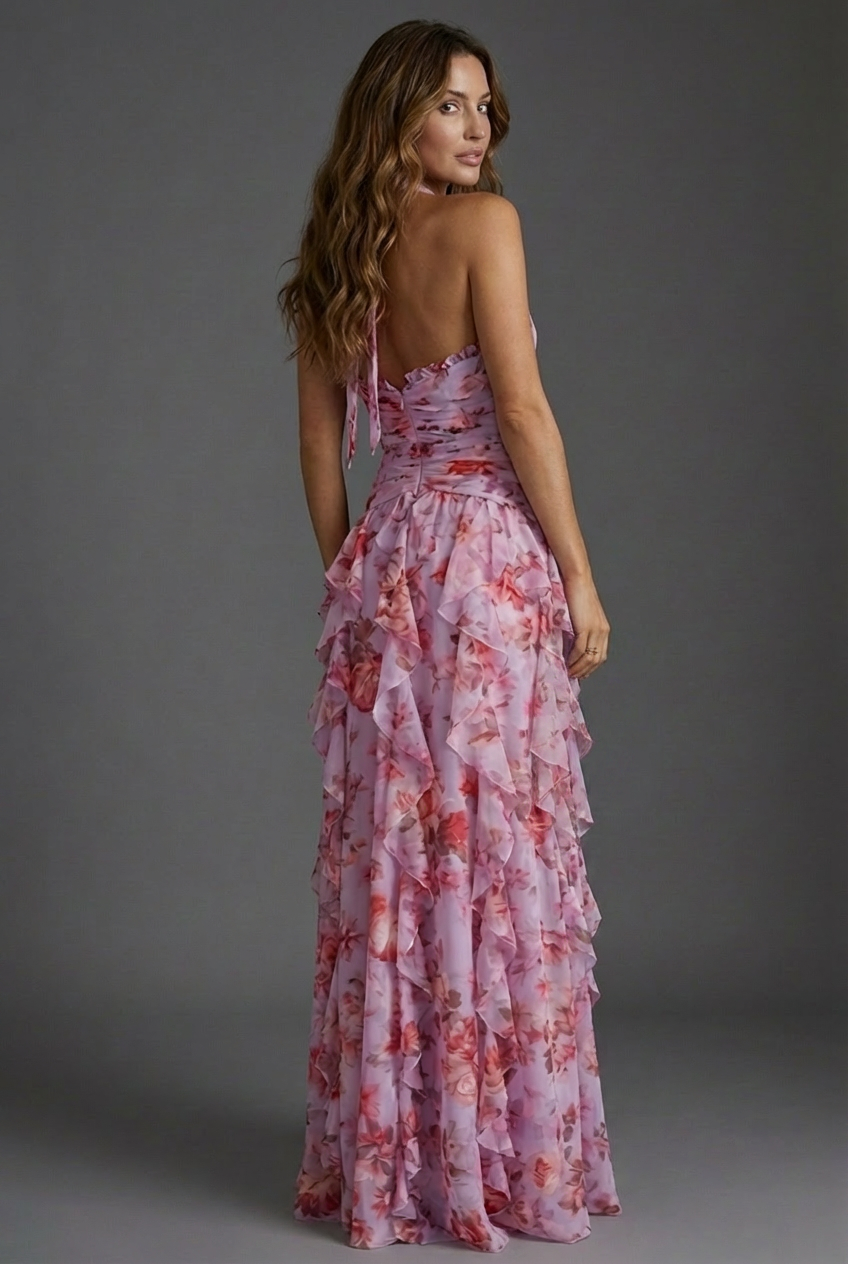 Detailed view of the vibrant floral pattern on a women's halterneck maxi wedding guest dress, elegant party wear.