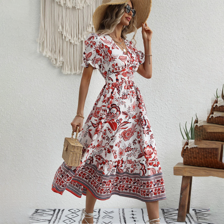 Close-up of elegant floral dress fabric, showcasing puff sleeves and vibrant spring/summer pattern.