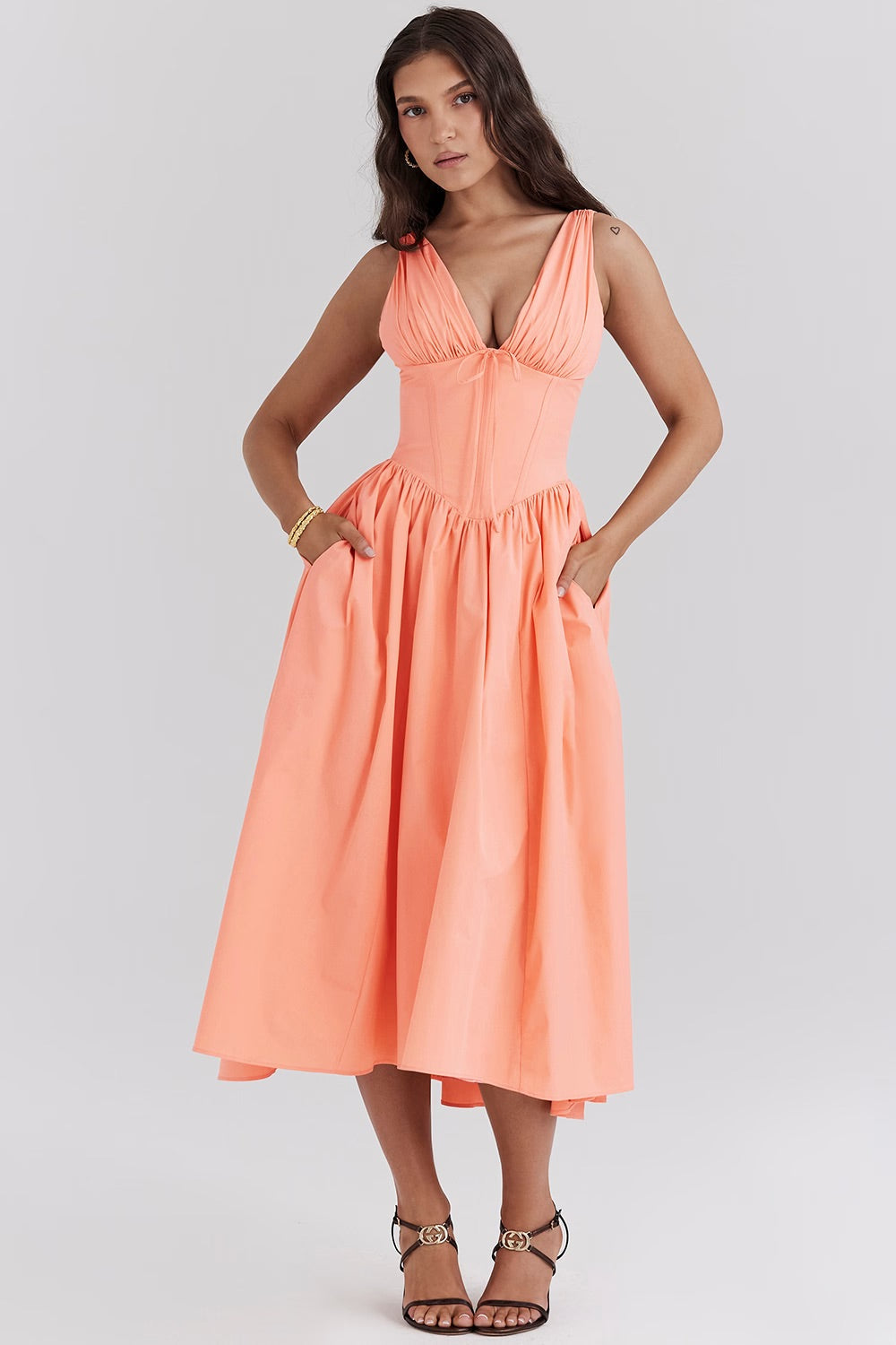 Blue floral V-neck midi wedding guest dress with flattering corset bodice for summer occasions.