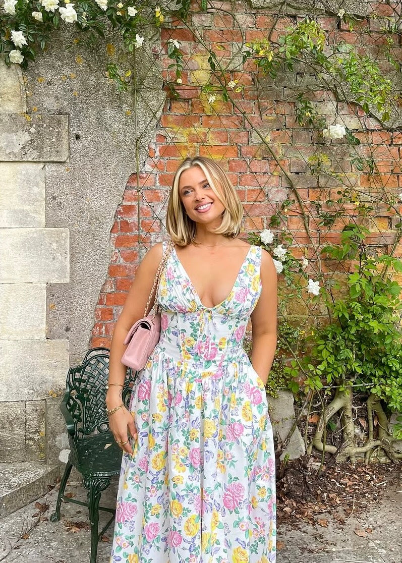 Beautiful peach floral V-neck corset dress, an elegant midi for wedding guests or special summer events.