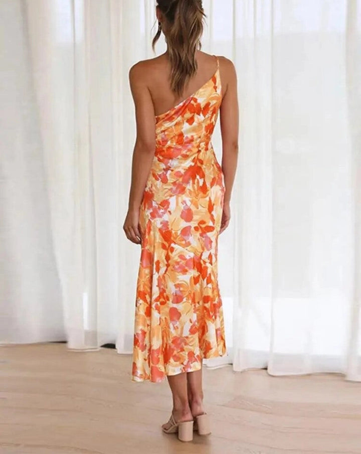Women's elegant floral one-shoulder midi dress, a sophisticated choice for wedding guests.
