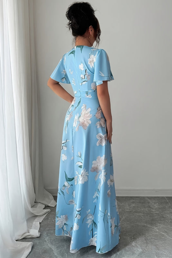 Sophisticated women's pleated midi dress in a vibrant floral print, perfect for sunny days.