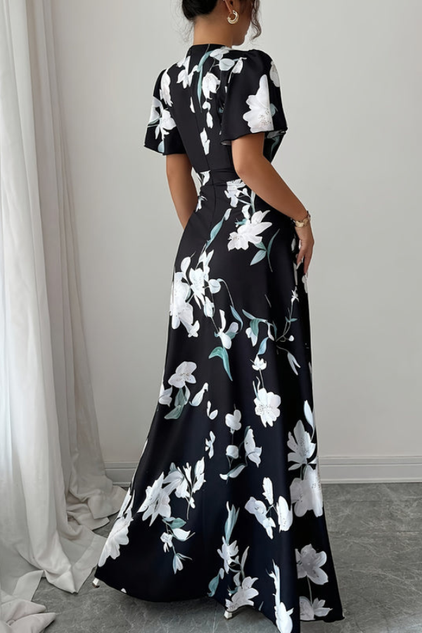 Feminine pleated midi dress featuring a vibrant floral pattern, suitable for casual or party wear.