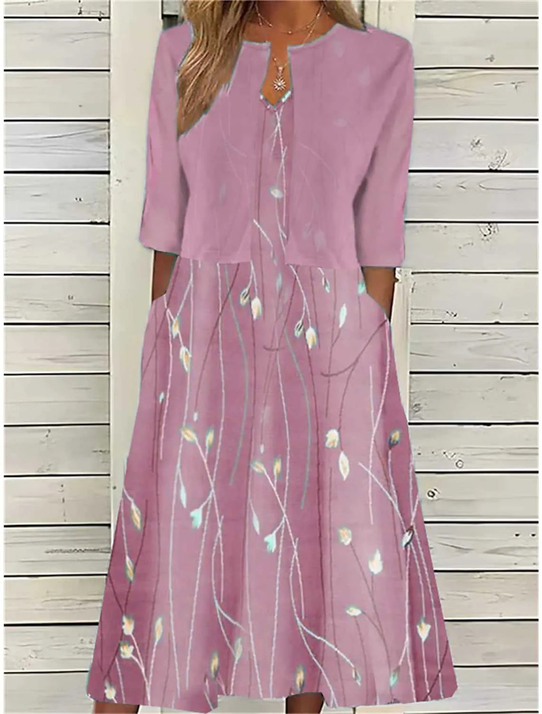 Chic women's floral print midi dress featuring practical pockets. Ideal for elegant spring/summer daytime wear.