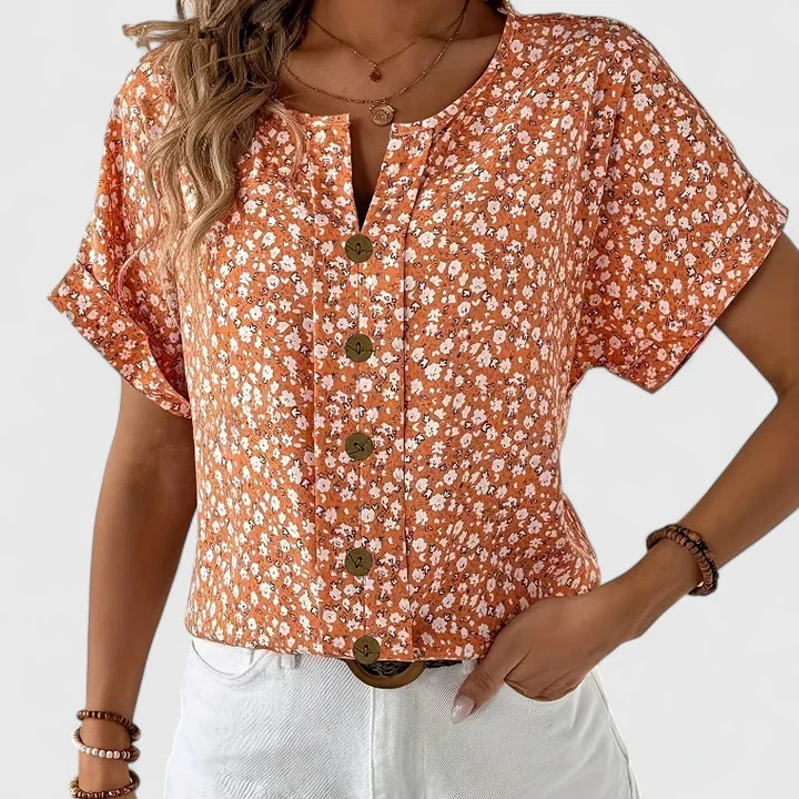 Women's long sleeve blouse with a delicate floral print. A flowy and chic top, perfect for spring fashion.