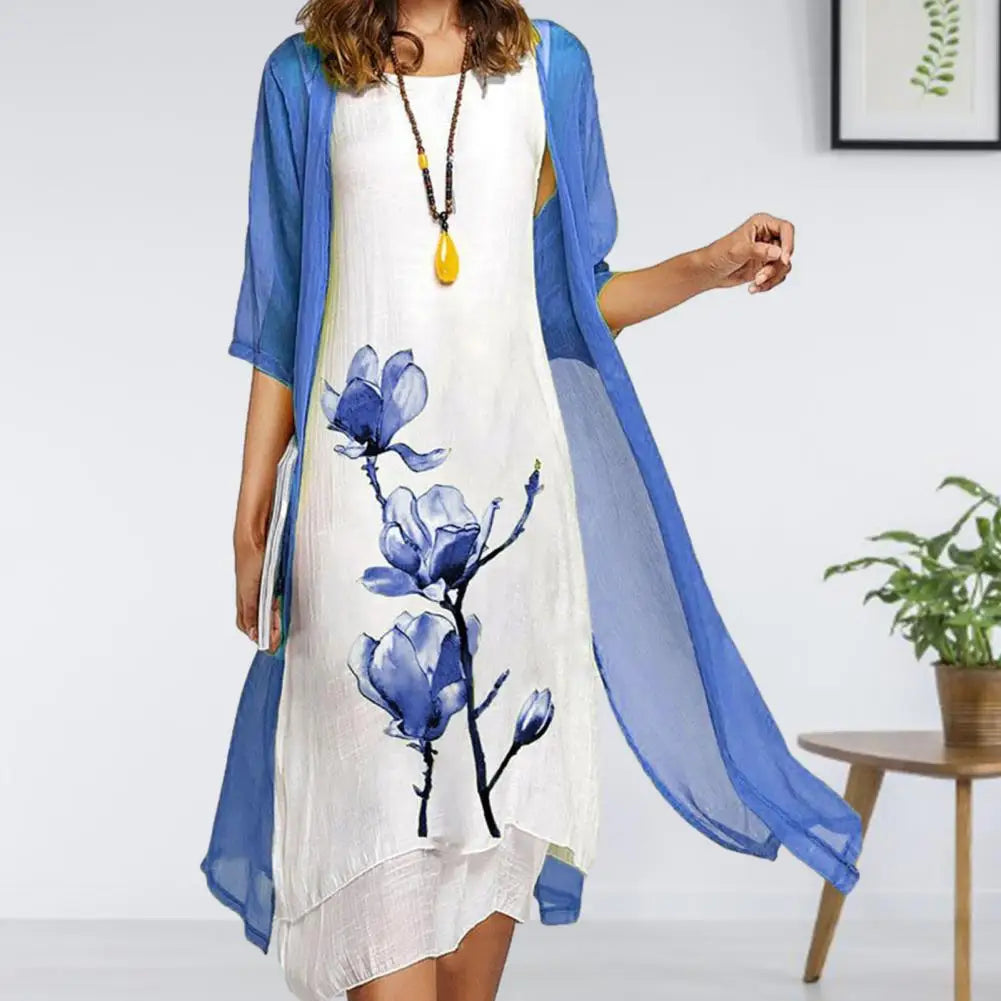 Stylish women's two-piece floral print midi dress set featuring a light sheer cardigan. Summer fashion.