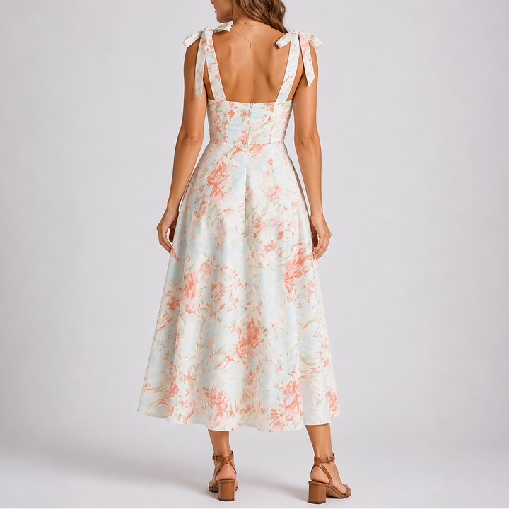 Flattering A-line floral print ruched midi dress for women, designed with adjustable straps for comfortable spring/summer wear.