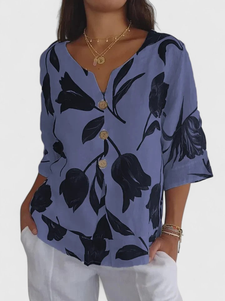 Comfortable women's V-neck blouse with vibrant floral print. Elegant everyday top, perfect for versatile fashion.