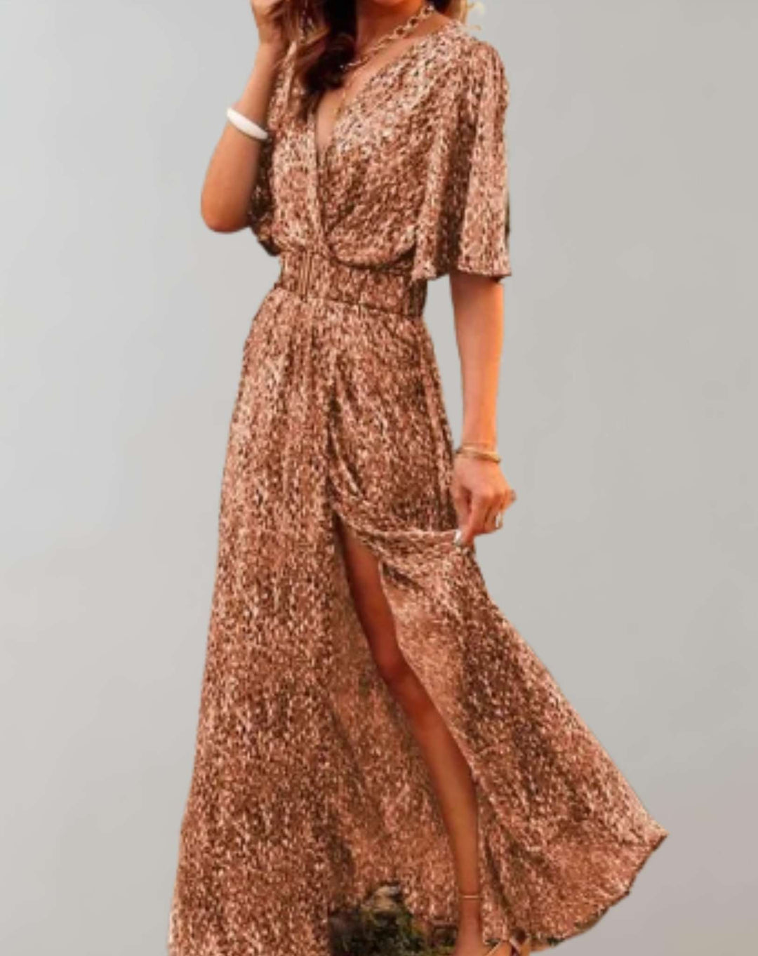 Woman wearing elegant floral wrap maxi dress with high side slit, walking gracefully, ideal for summer events.