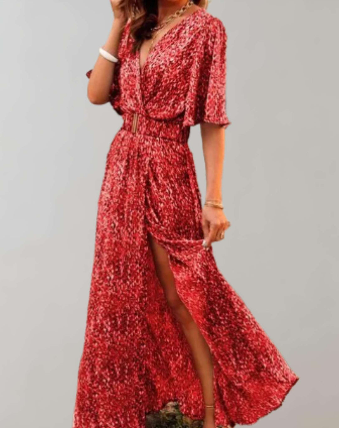 Stylish woman in elegant floral V-neck wrap maxi dress with side slit, perfect for a casual chic summer look.