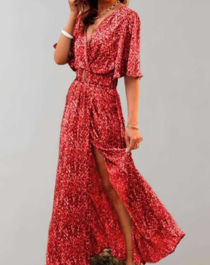 Stylish woman in elegant floral V-neck wrap maxi dress with side slit, perfect for a casual chic summer look.