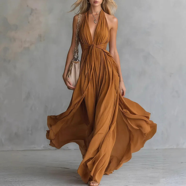 Flowing silhouette women's backless halter maxi dress with a graceful side slit, perfect for elegant summer events.