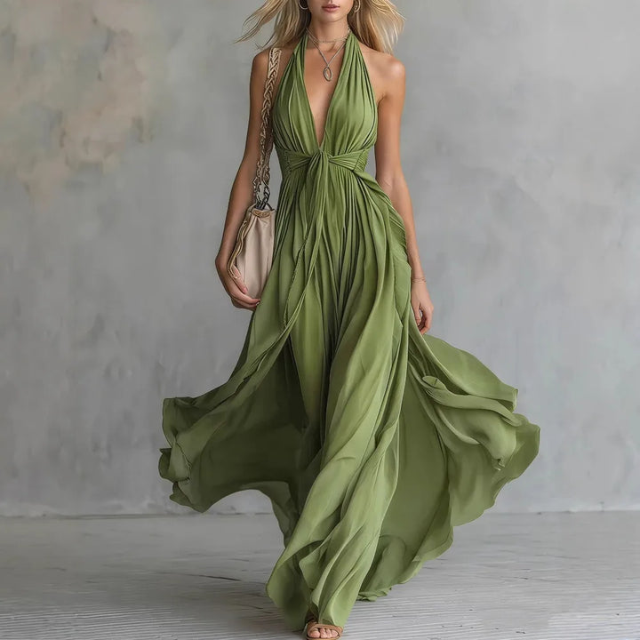 Gorgeous flowy pleated backless maxi dress for women. Perfect long formal wear with a chic halter neckline.