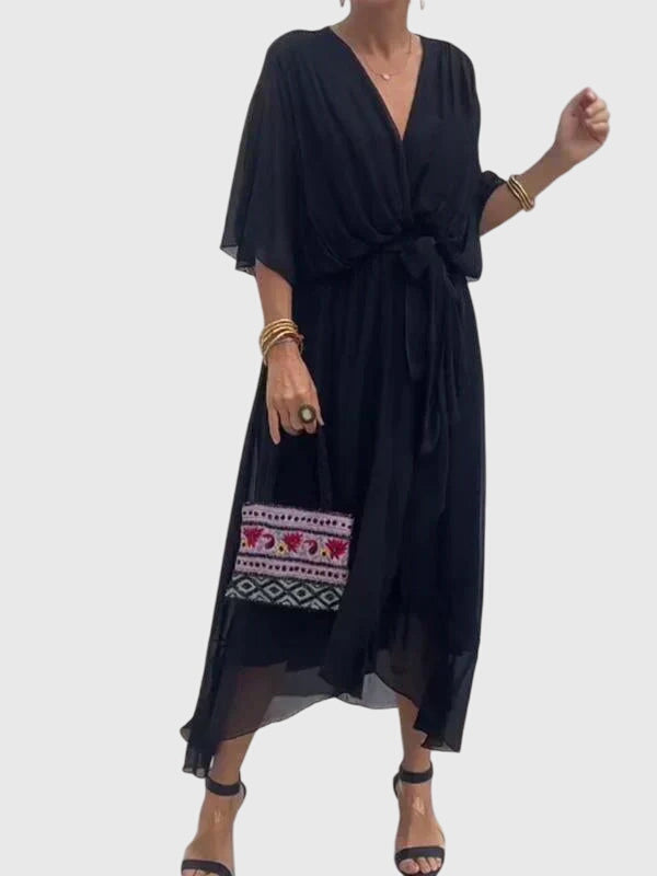 Close-up of soft fabric on a comfortable women's elegant flowy maxi dress, versatile for events.