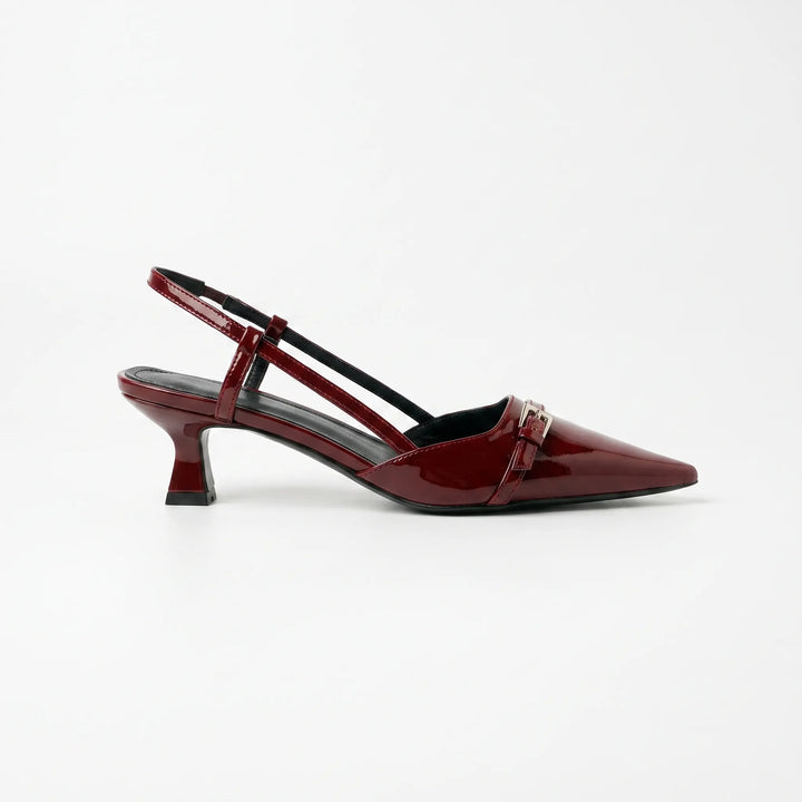 Close-up of women's glossy pointed toe slingback heels, showcasing elegant finish & comfortable design for dressy occasions.