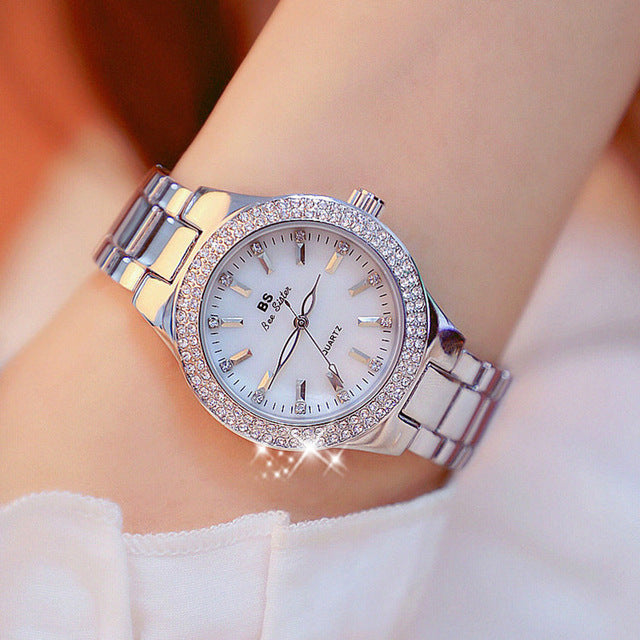 Women's sleek stainless steel elegant timepiece, featuring a quartz movement, round dial, and comfortable push-button clasp.