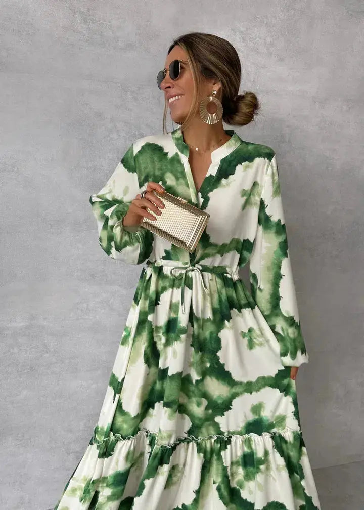Elegant women's green maxi dress with puff sleeves & flowing tiered skirt, perfect for formal events & evening wear.