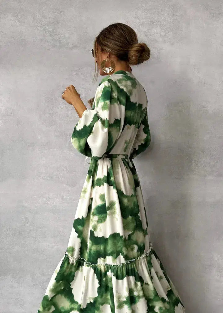 Beautiful women's green evening gown with elegant puff sleeves & flowing tiered skirt, ideal for special occasions.