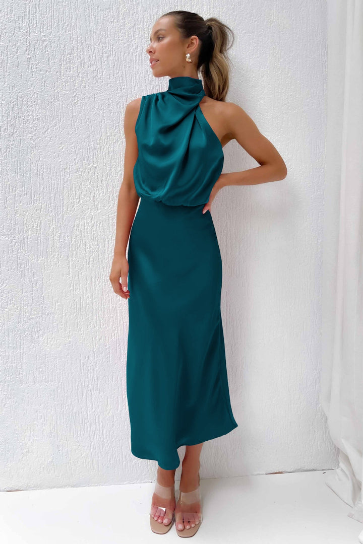 Flowing women's evening gown, halter neck, open back detail, floor-length for formal parties.