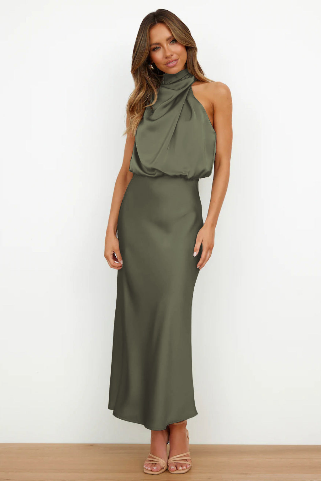 Long elegant women's evening dress, halter top, open back, flowing skirt for a glamorous gala.