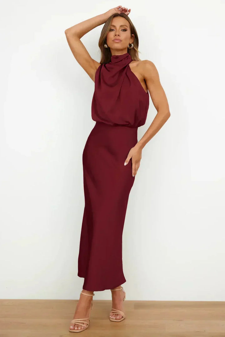 Detailed view of the elegant fabric of a women's halter evening dress with open back.