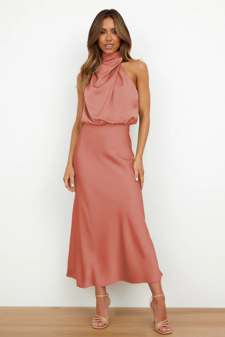 Luxurious fabric of a women's sophisticated halter evening dress with an open back.