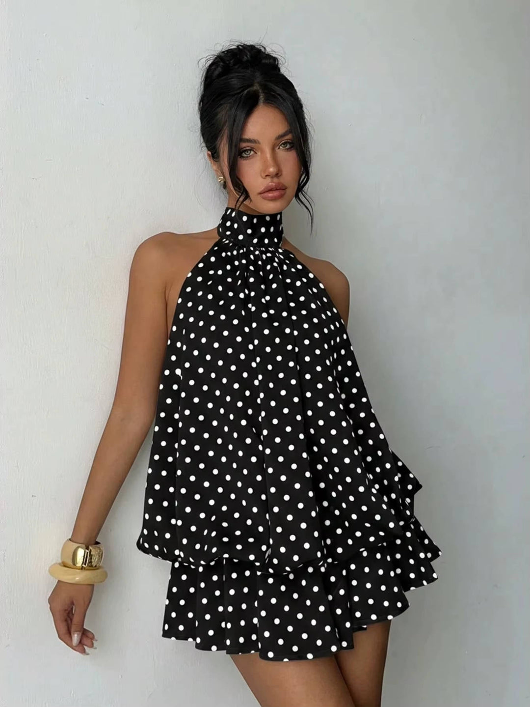 Dainty women's cocktail mini dress, featuring a halter design and a charming ruffle hem.