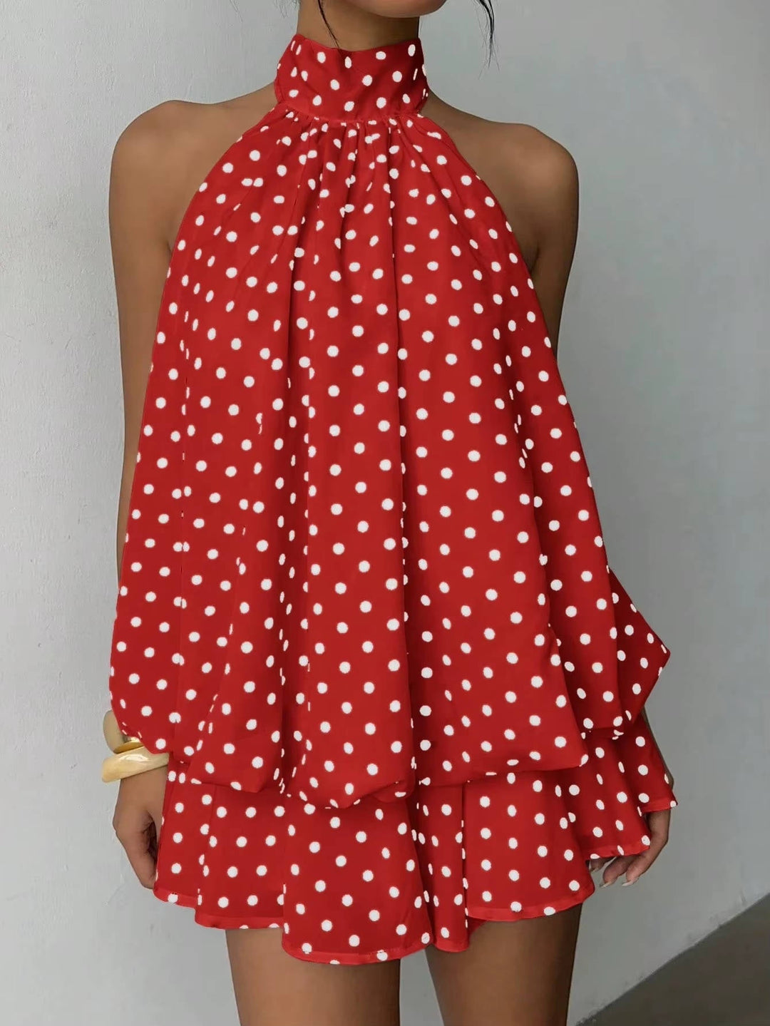 Stylish women's summer dress, a halter mini with a fashionable ruffle hem for parties.