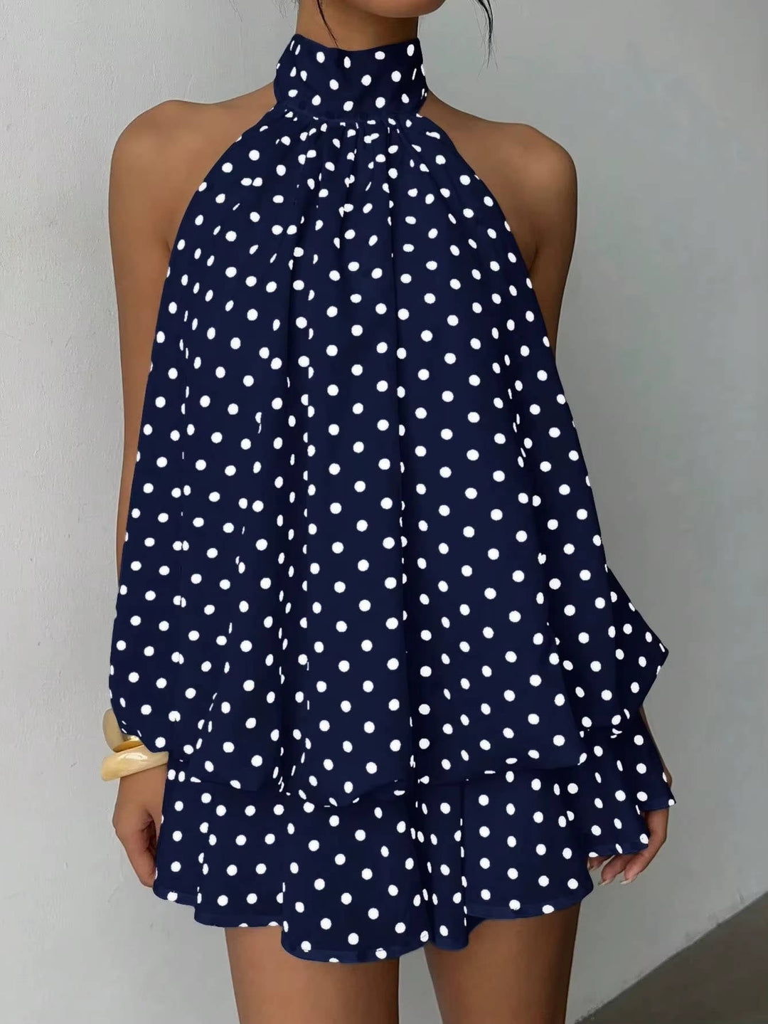 Elegant women's sleeveless halter dress with a playful ruffle hem, great for any party.