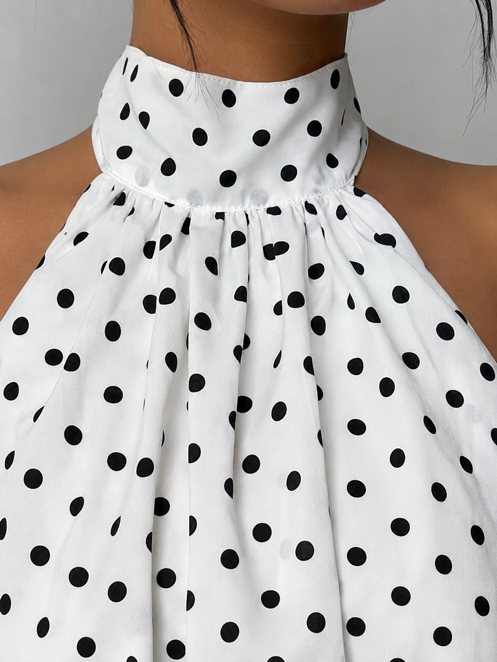 Stylish women's sleeveless party dress featuring a halter neckline and delicate ruffle hem.