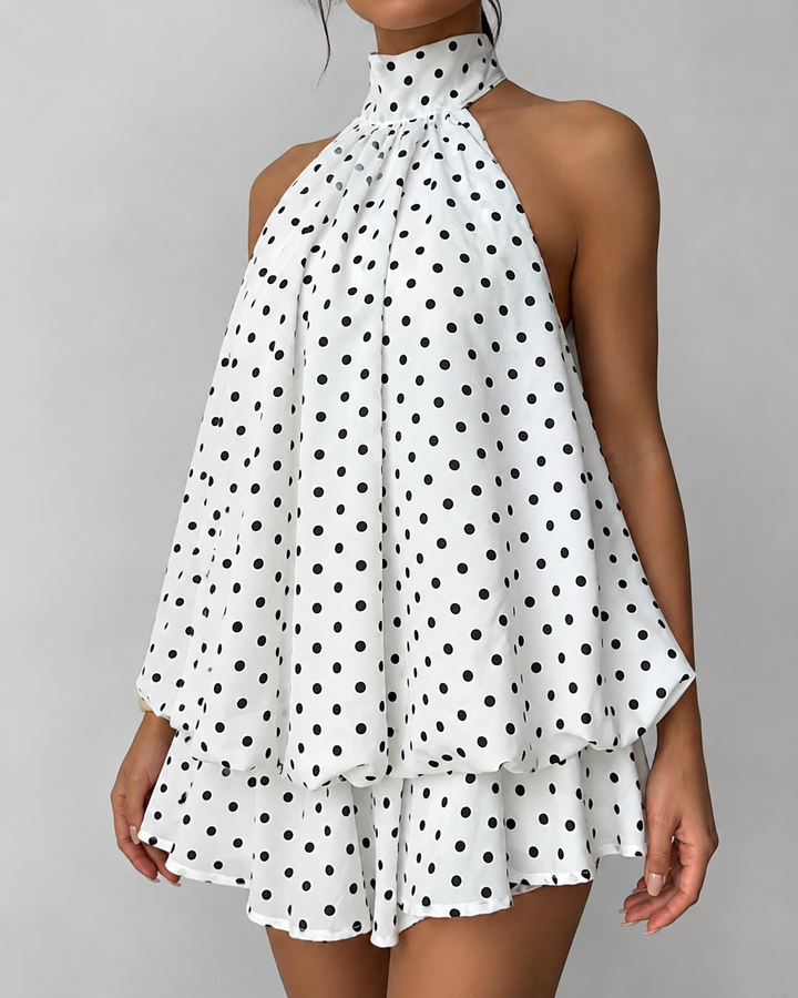 Chic open-back mini dress for women with an elegant halter design and playful ruffle hem.